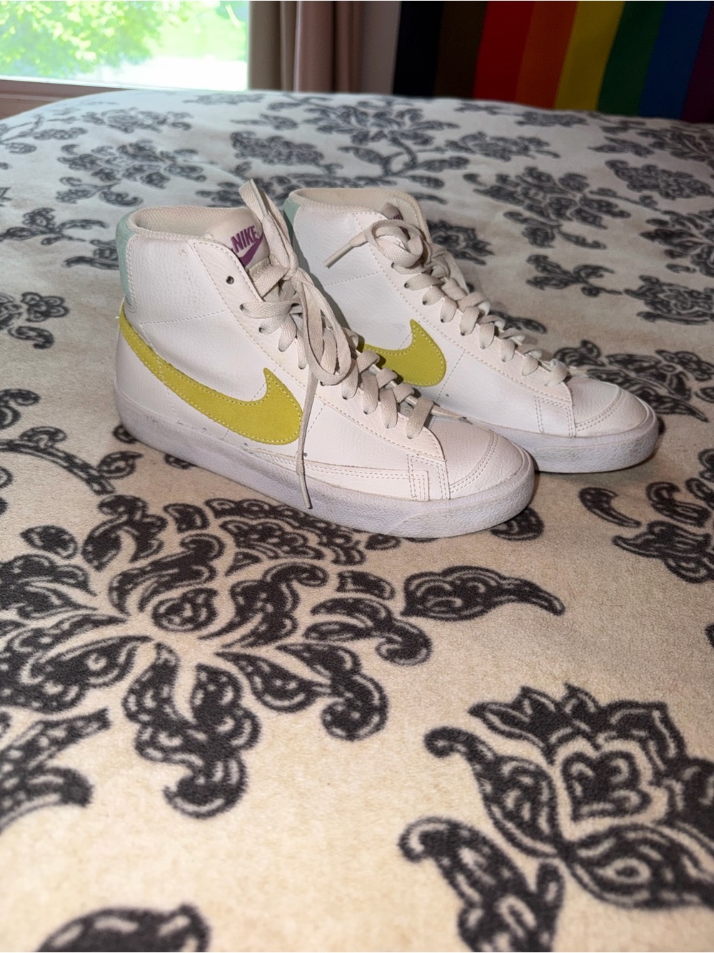 Nike Women's White High-Top Sneakers with Yellow Swoosh Accent